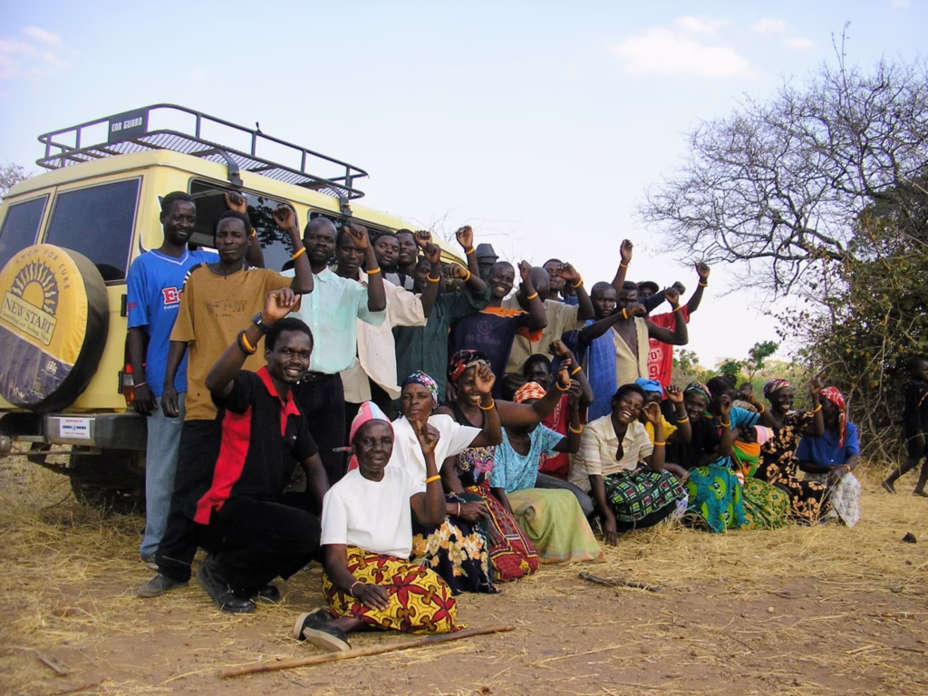 Man volunteering in Zambia, a great way to travel the world while holding a job] International volunteering can be a life-changing way to travel and work.
